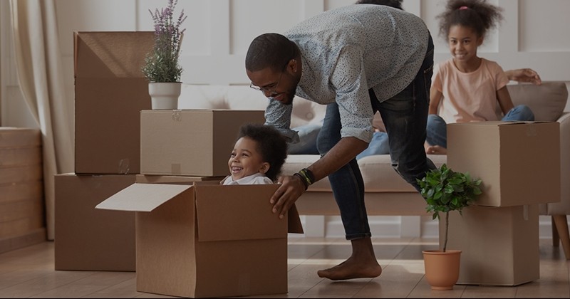 Man pushing kid in box