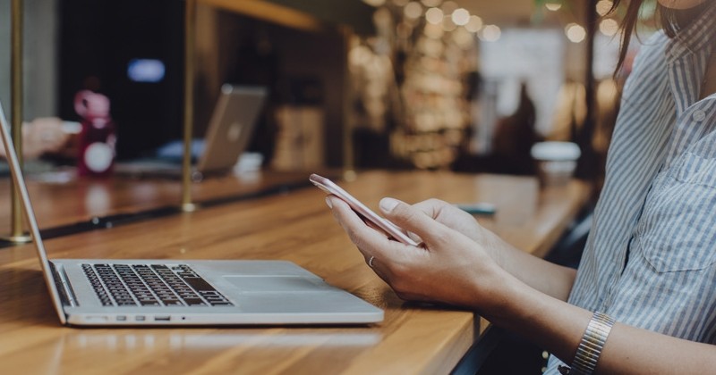 Woman with phone and computer