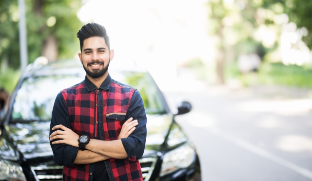 Young man by car