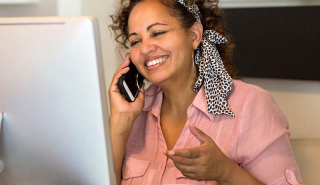 woman smiling at computer