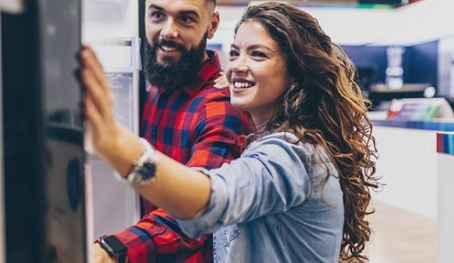 Couple looking at fridge