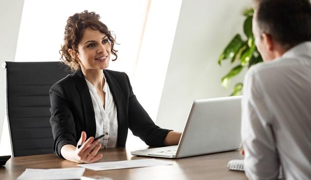 Woman at desk explaining