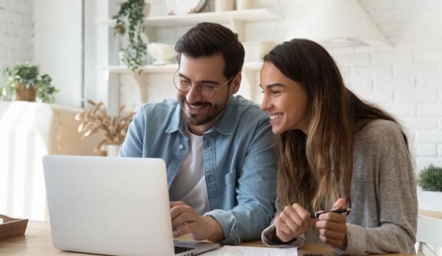 happy couple looking at computer