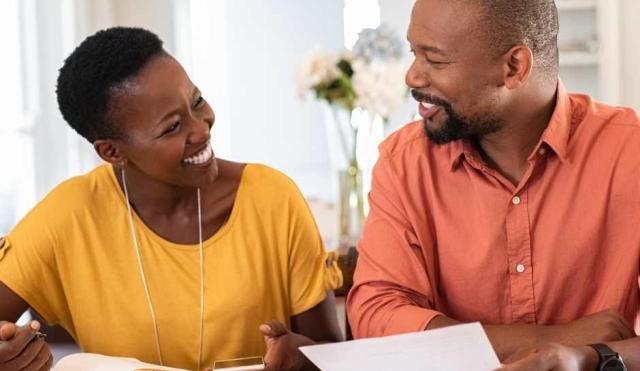 Couple going over finances together at table.