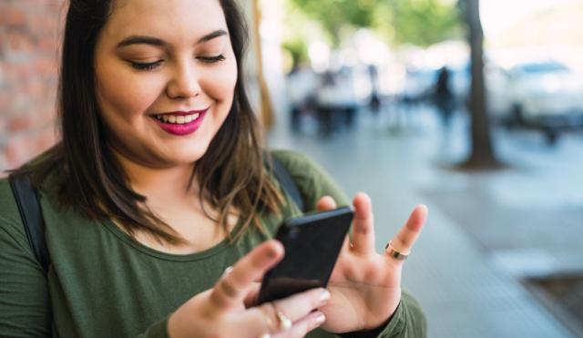 Woman checking her finances on her smart phone.