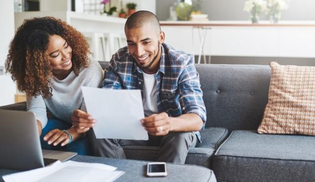 Couple looking at tax documents and smiling!