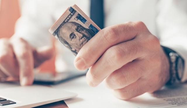 CLose up of person holding money.