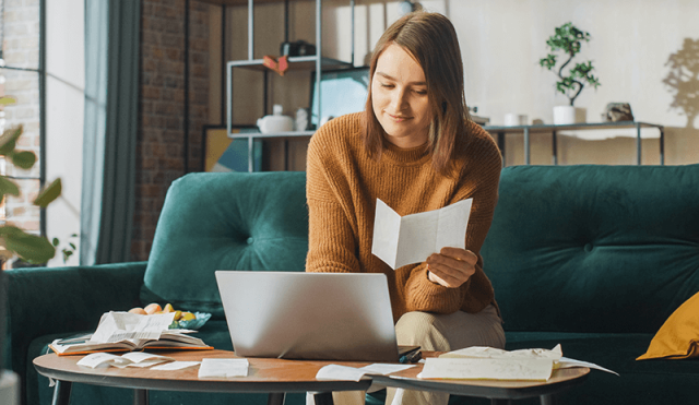 Woman on the couch doing taxes