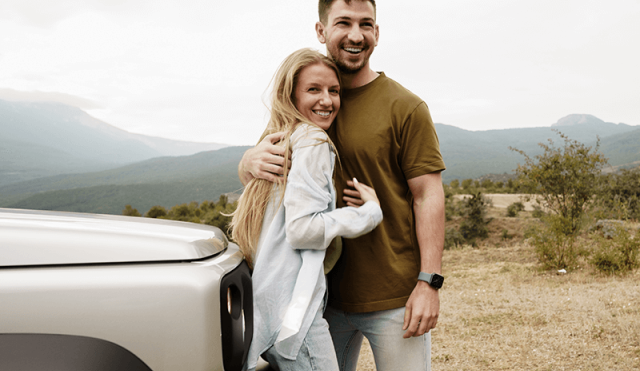 Couple with car in the mountains