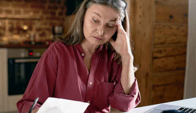 Stressed woman looking at paperwork