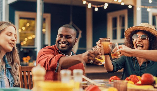 friends cheers at backyard dinner party