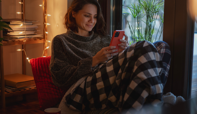 cozy woman shopping on phone