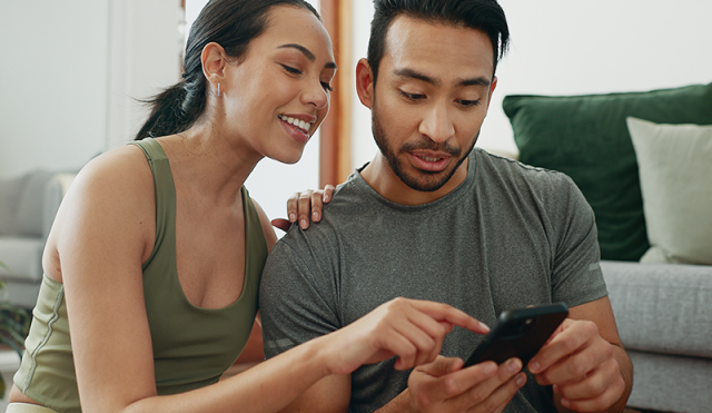 a couple looking at a phone