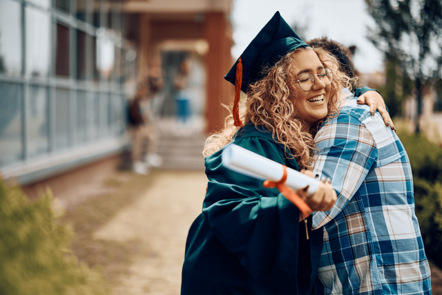 Graduate hugging a person