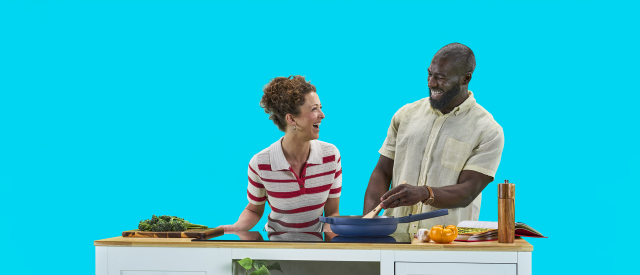 A couple cooking together in a kitchen
