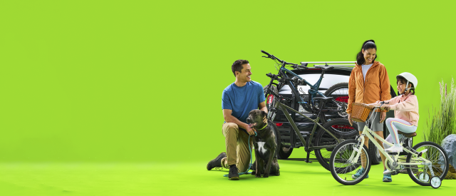 A family loads bikes onto a car