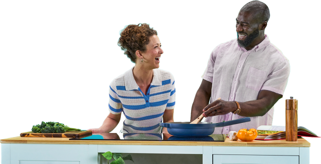A couple cooking together in a kitchen