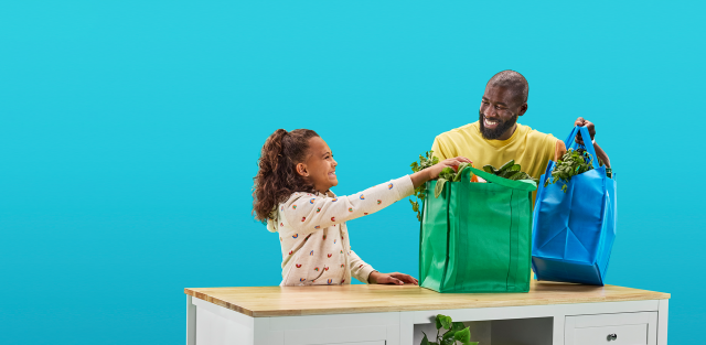 Father and daughter unpack groceries