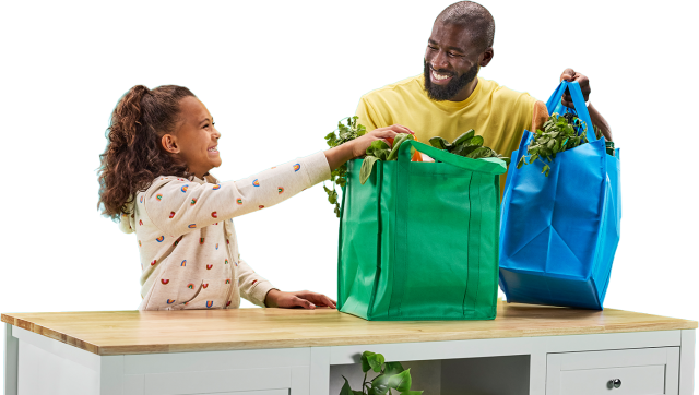 Father and daughter unpack groceries