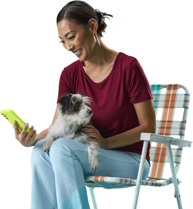 woman sitting with a dog and phone