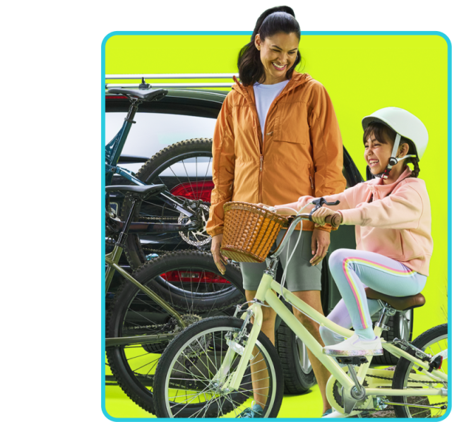 mom looks at daughter riding a bike