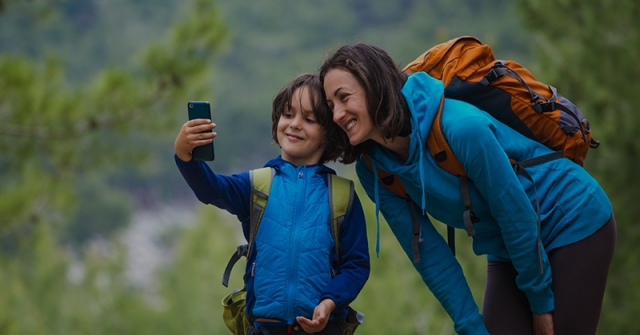 Child taking picture with mom