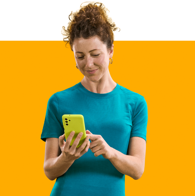 woman on phone with an orange background