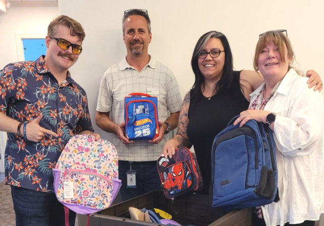 CUofCO employees holding backpacks
