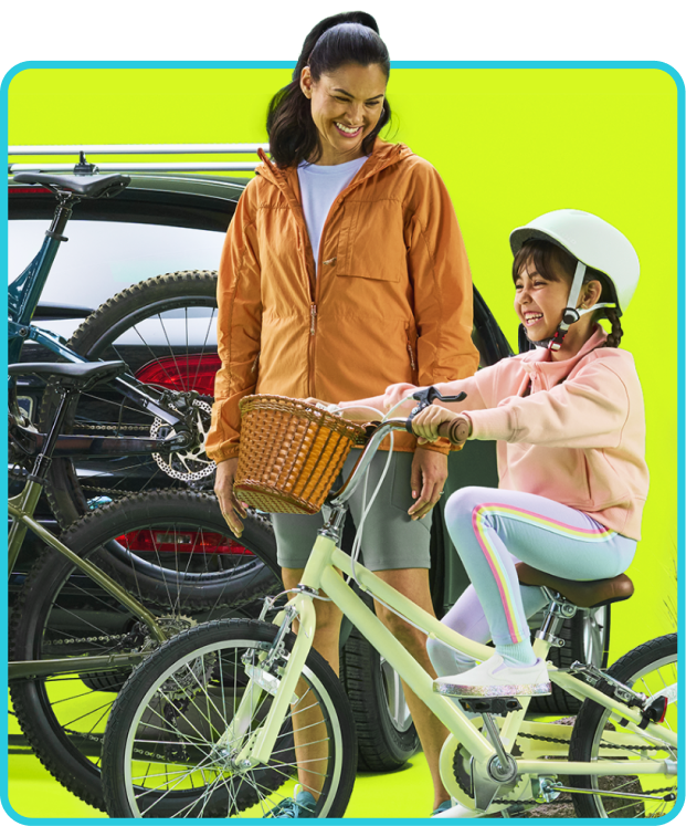 mom looks at daughter riding a bike