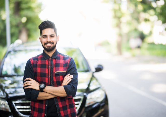 Young man by car