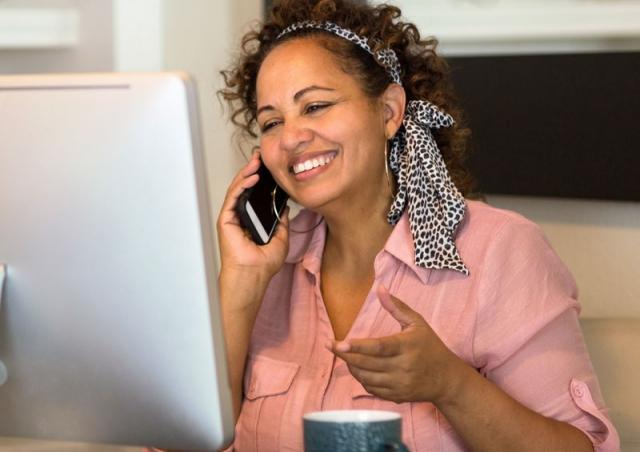 woman smiling at computer