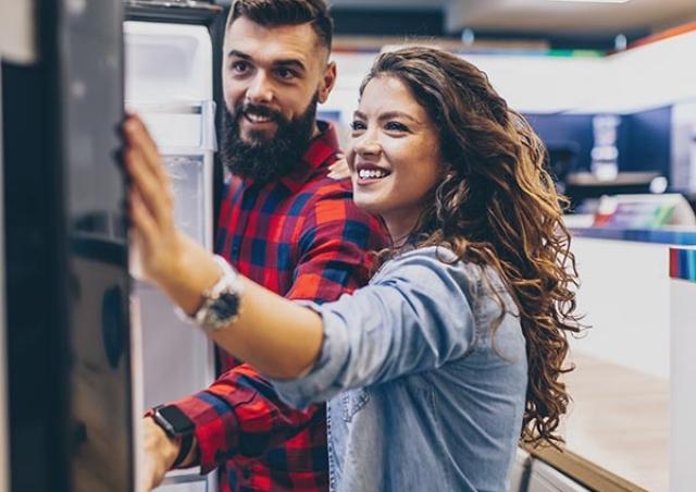 Couple looking at fridge