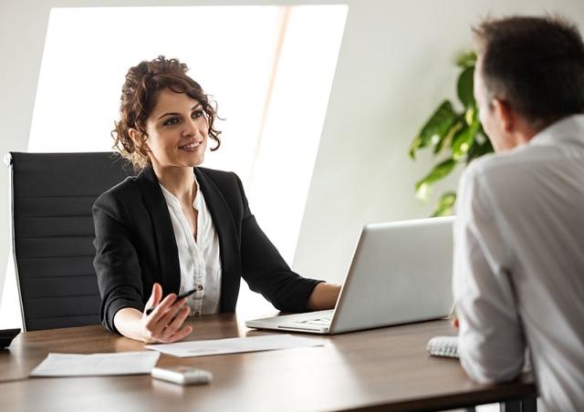 Woman at desk explaining