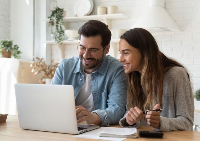 happy couple looking at computer