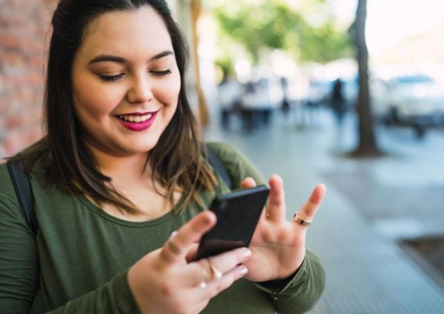 Woman checking her finances on her smart phone.