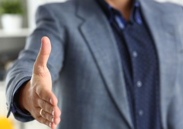 predatory lender reaching out to shake your hand.