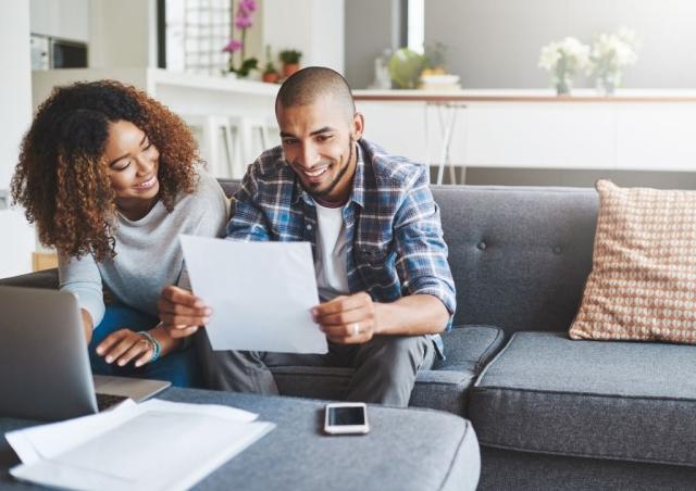 Couple looking at tax documents and smiling!