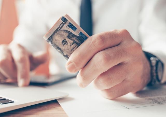 CLose up of person holding money.