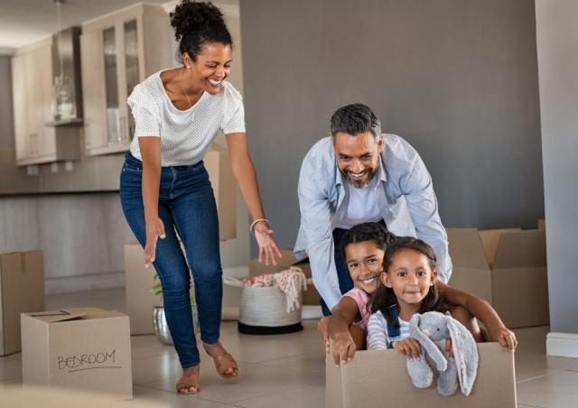 Family having fun in new house