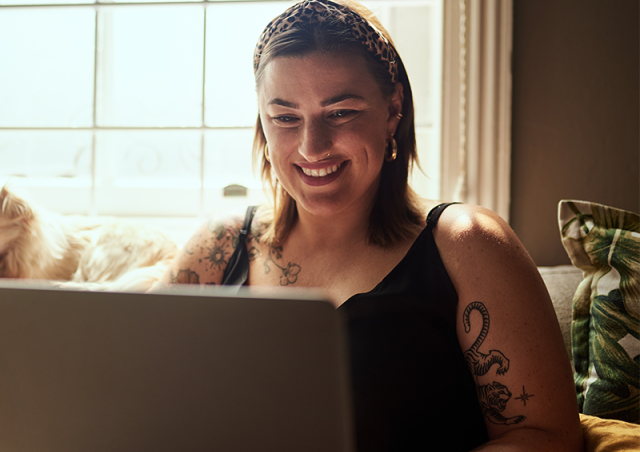 woman on laptop smiling