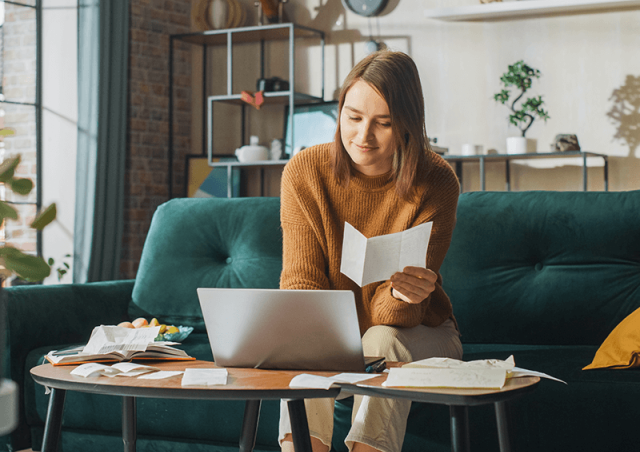 Woman on the couch doing taxes