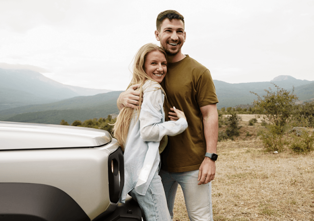 Couple with car in the mountains