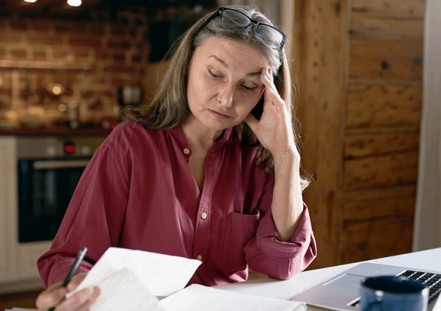 Stressed woman looking at paperwork