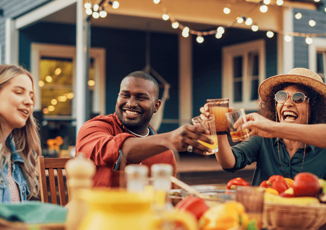 friends cheers at backyard dinner party