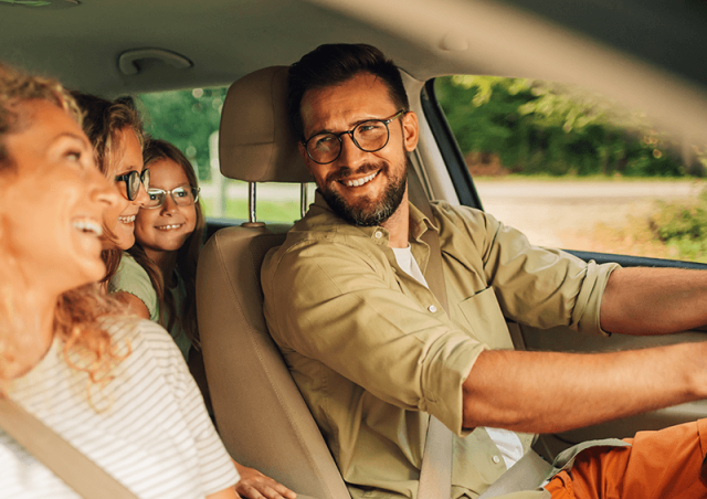 family looking at each other inside a vehicle