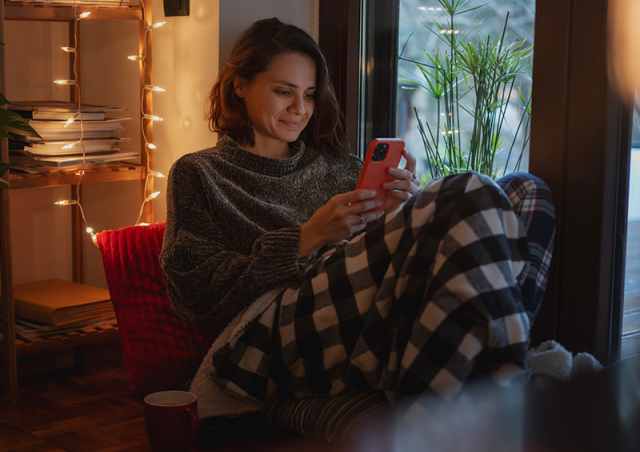 cozy woman shopping on phone