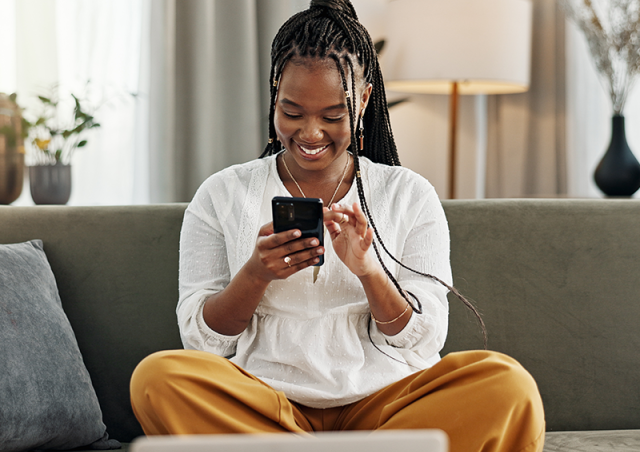 woman looking at phone and smiling